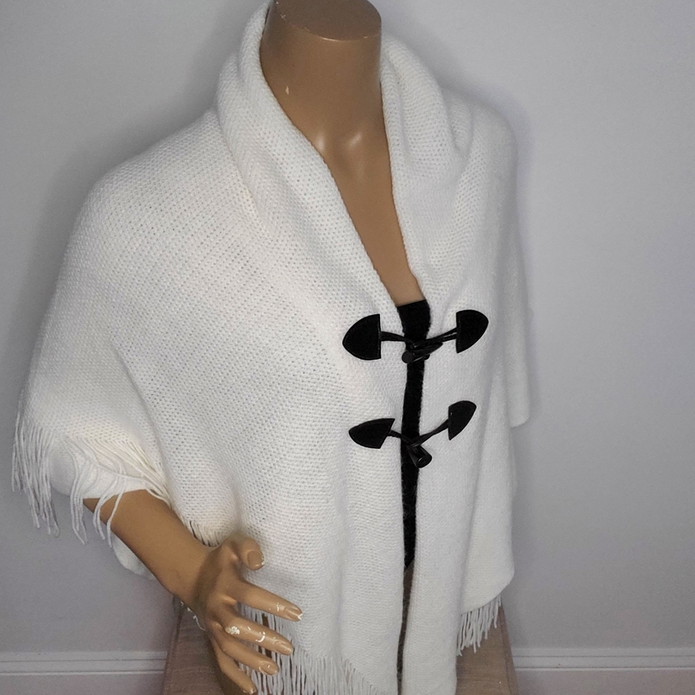 Off white fringed ponch with brown looped buttons